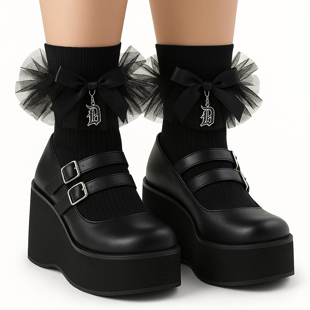 Black platform shoes with tulle bows and decorative elements on a white background